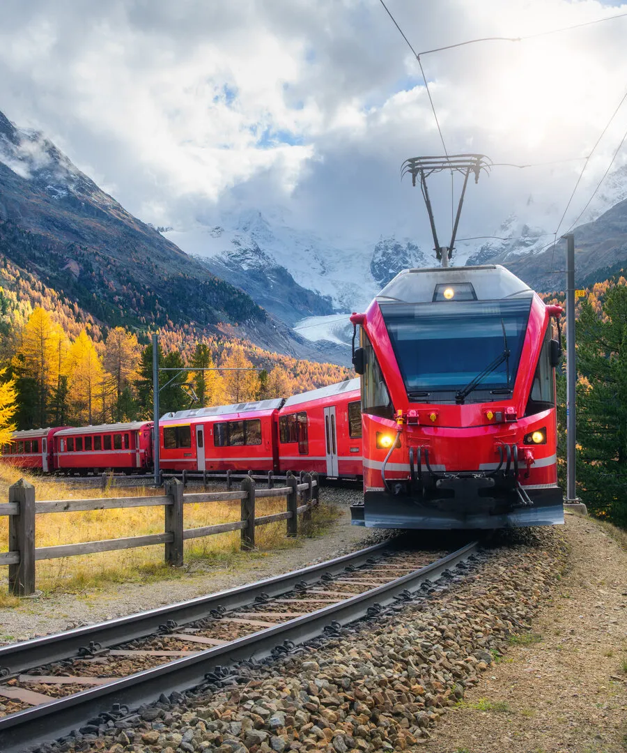 A scenic train journey through the mountains, framed by autumn landscape